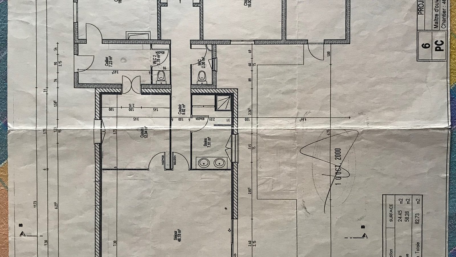 Architect's plan of a house before renovation, laid on a table